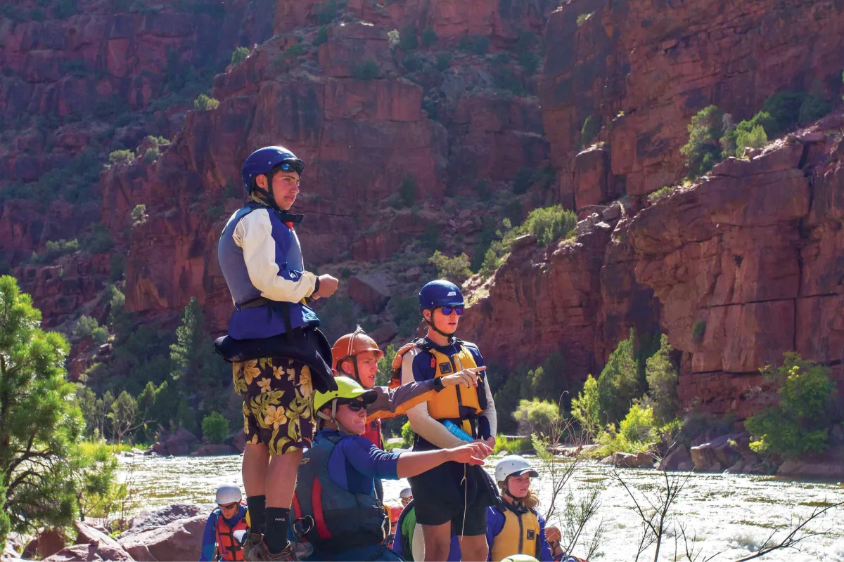 Students discussing route planning strategies for the whitewater ahead.