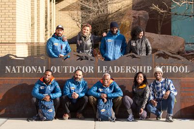 Expedition Denali pose in front of NOLS World Headquarter sign