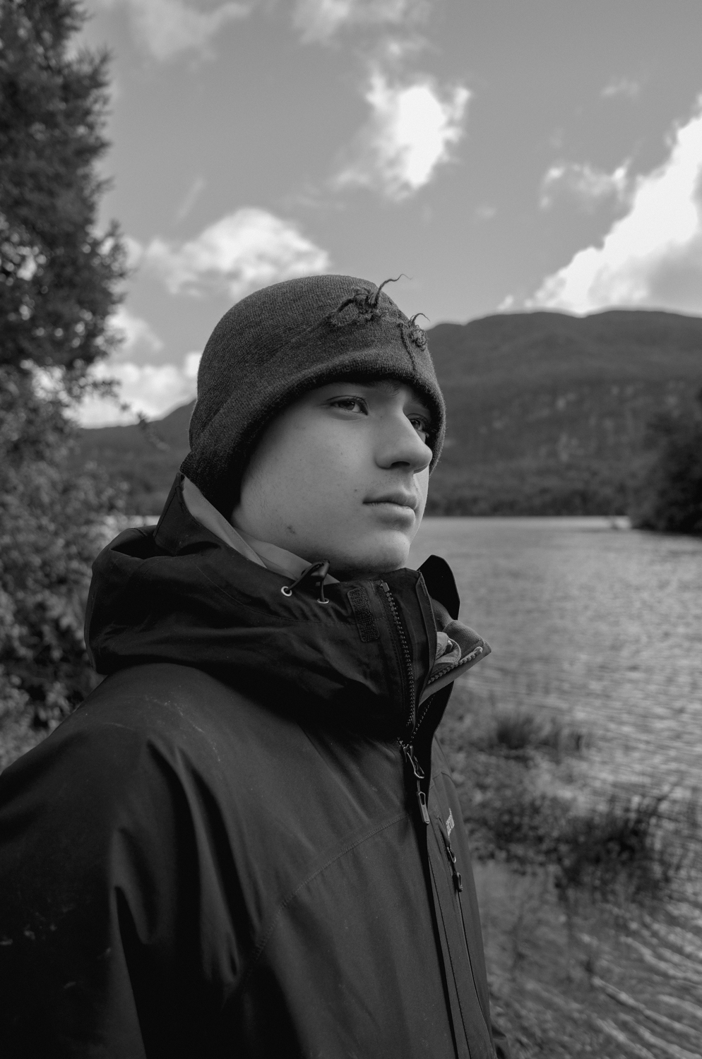 Close up of person wearing a hat by a river