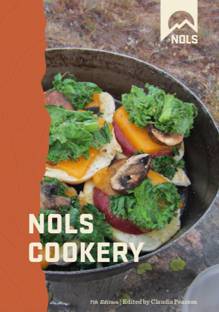 book cover of the NOLS Cookery, 7th edition, with picture of meal prepared on a NOLS course