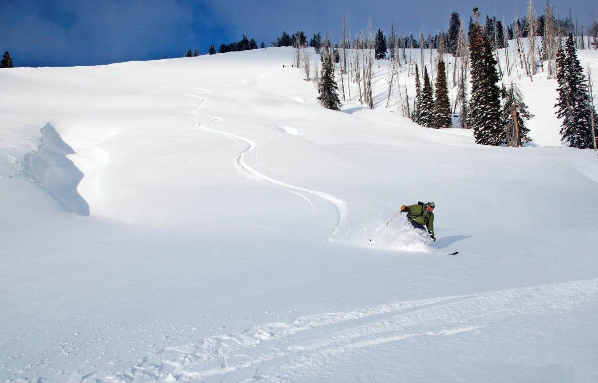 Single skier going down a slope