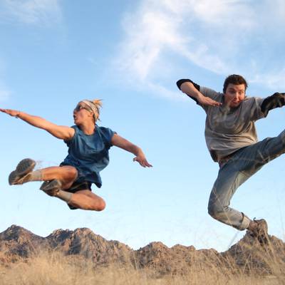 Two students jump kick for the camera in the Coronado National Forest.